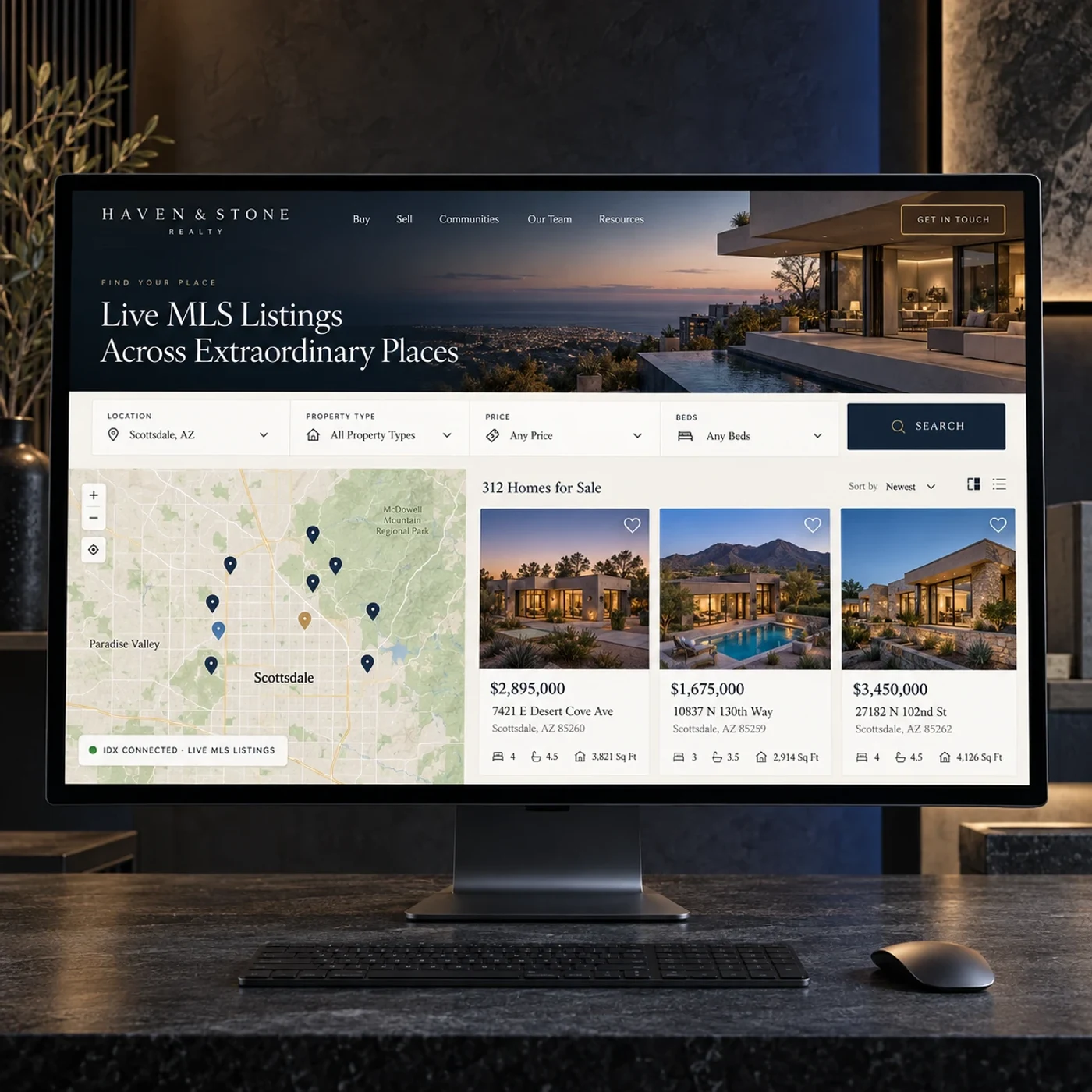 A real estate website showing live MLS listings with a map search, open on a desk monitor